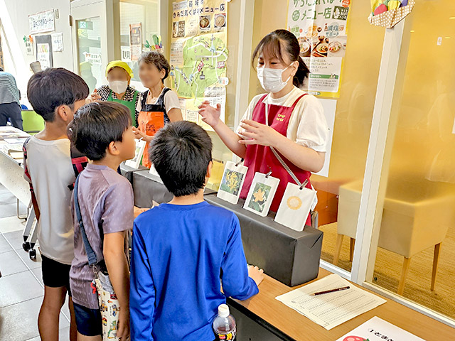 野菜クイズの食育をする学生